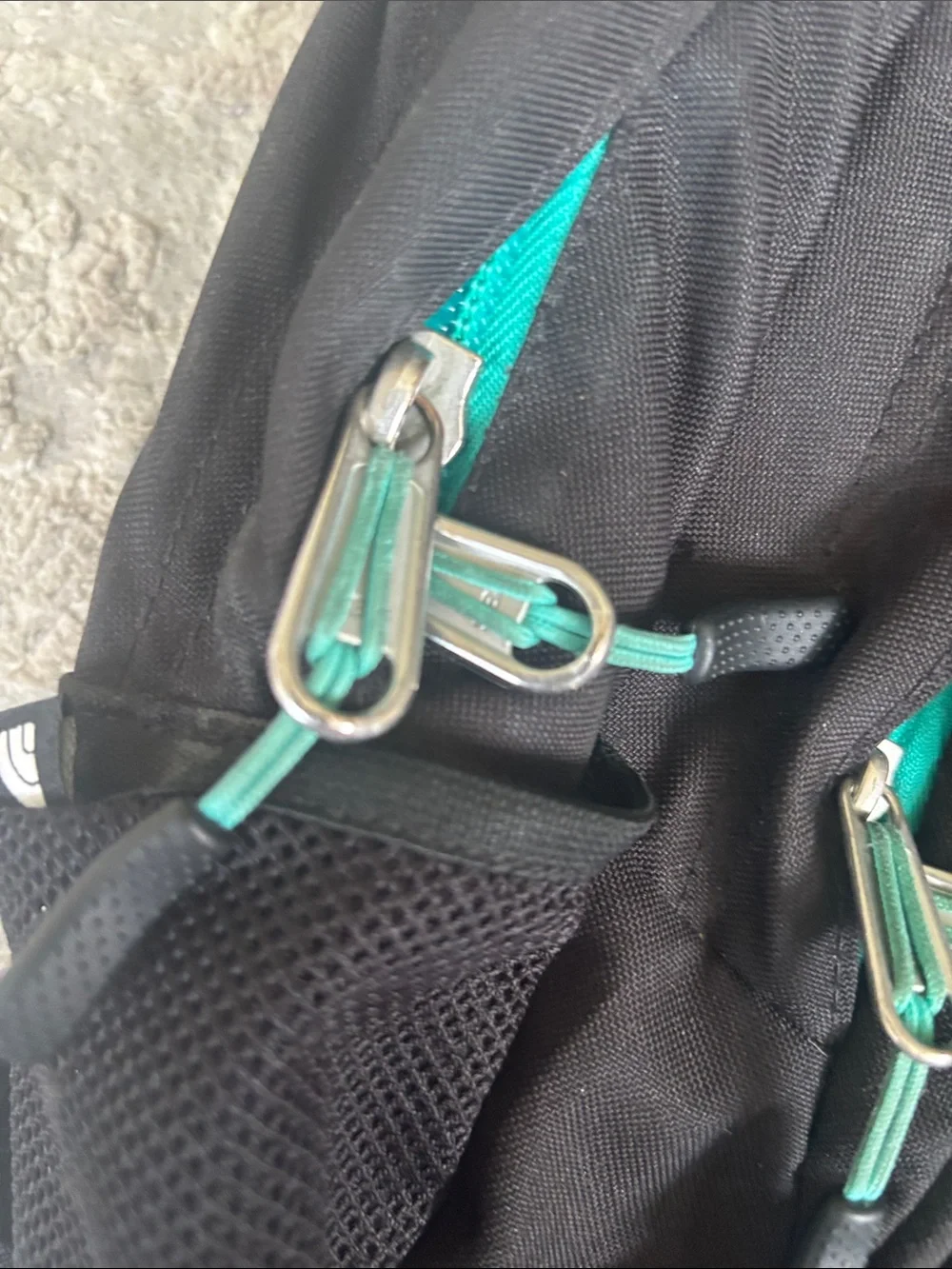 The North Face Black Backpack with Teal Trim and Bungee
